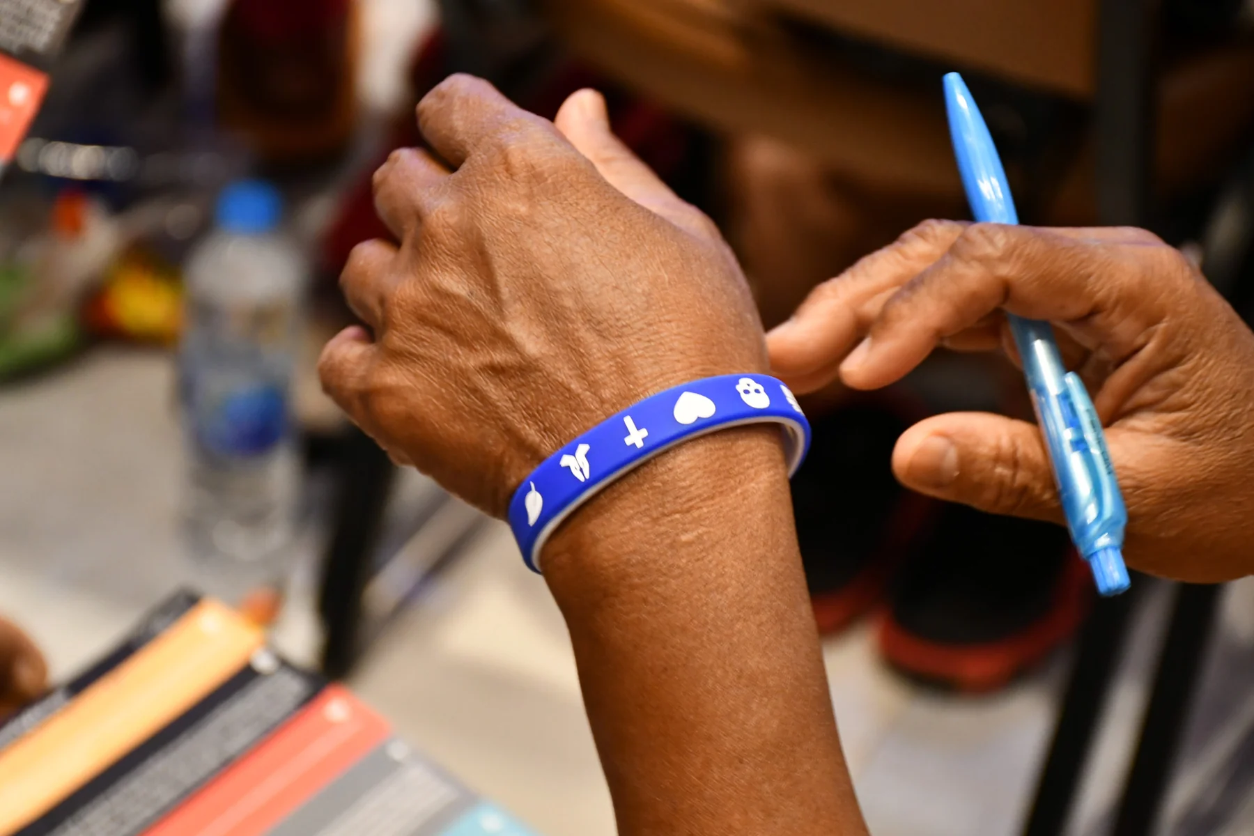 A person wearing an In His Name Gospel Wristband