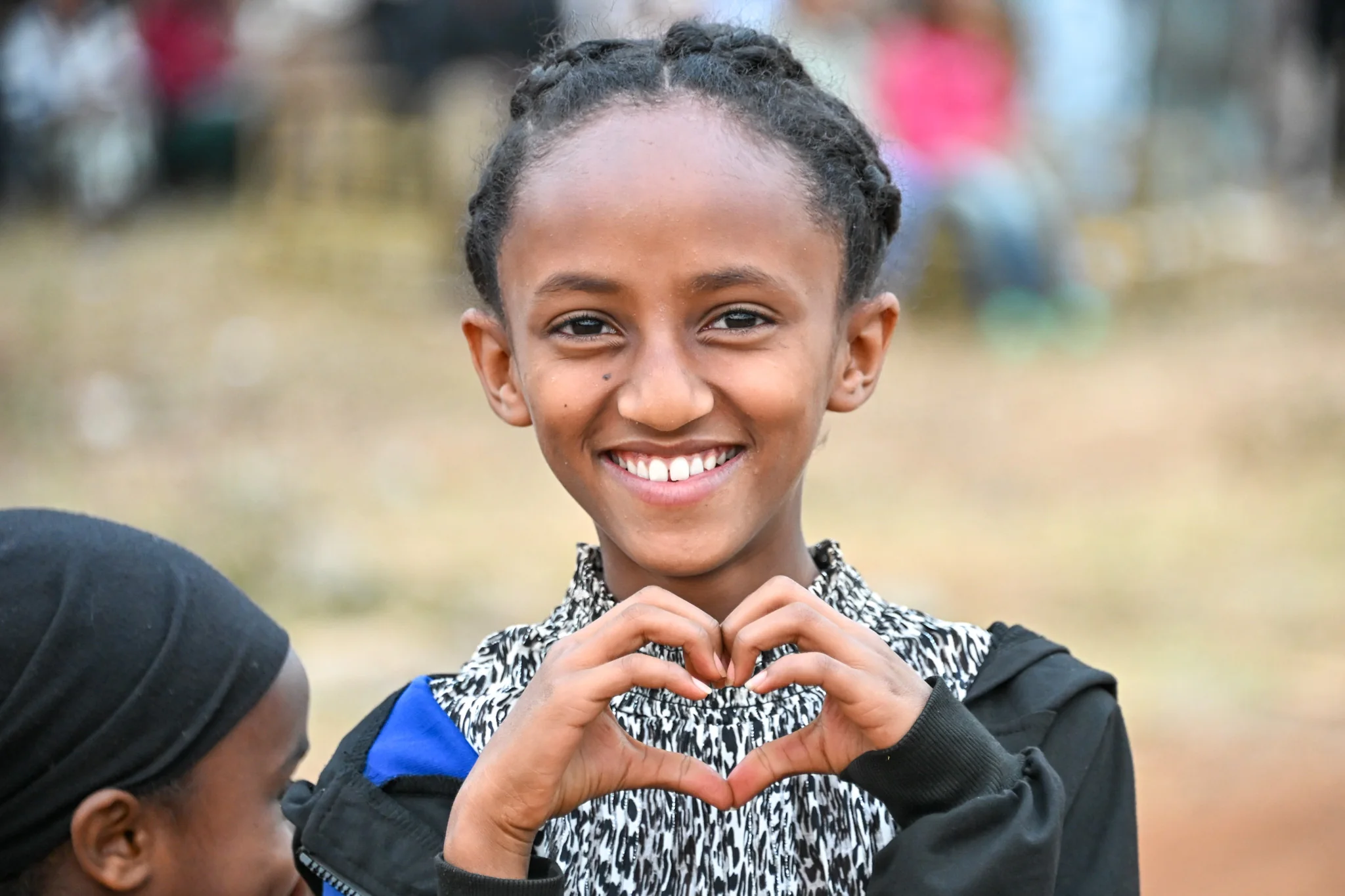 Young woman forming a heart with her hands