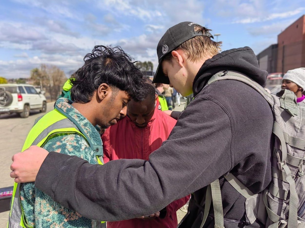 Street outreach team praying with someone