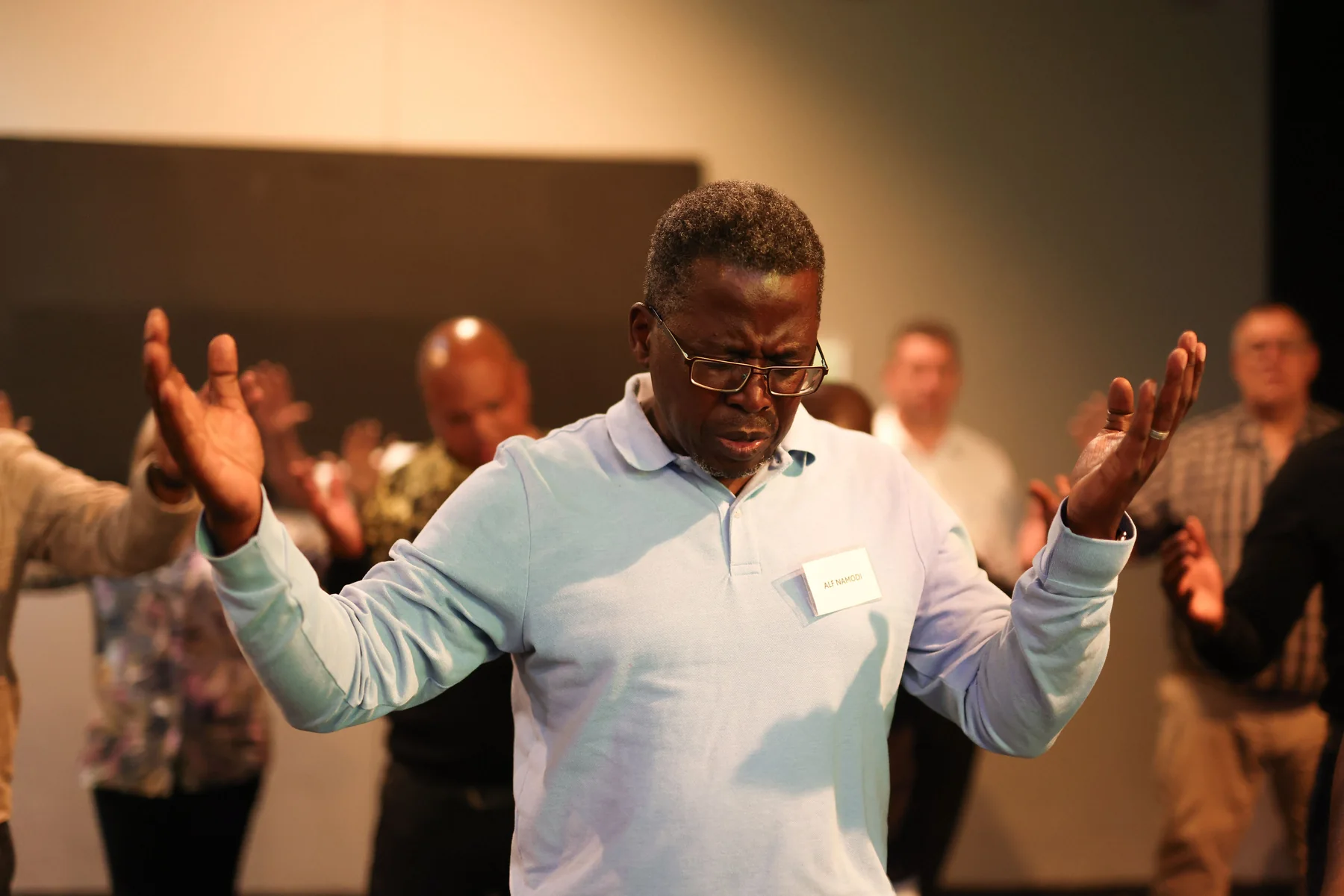 Evangelist praying at a ministry gathering